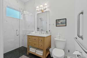 Full bathroom featuring vanity and a marble finish shower