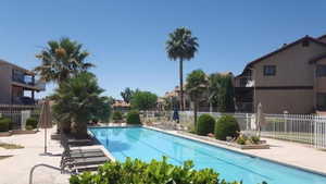 Community pool featuring a patio area and a balcony
