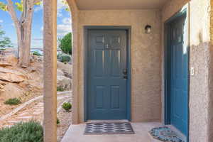 Entrance to property with stucco siding