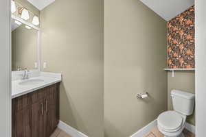 Bathroom with light tile patterned floors and vanity