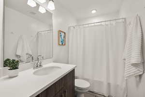 Full bathroom featuring vanity and curtained shower