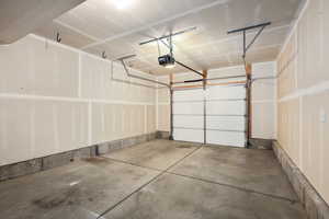 Garage featuring a garage door opener