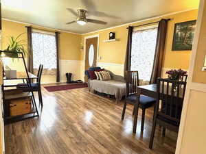 Living room featuring crown molding, plenty of natural light.