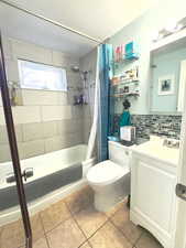 Bathroom with tub/shower combo, upgraded tile and backsplash.