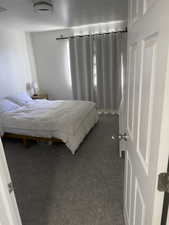Bedroom featuring carpet flooring and a textured ceiling