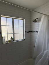 Full bath featuring shower / tub combo with curtain