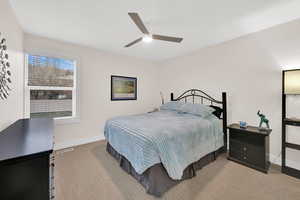 Bedroom featuring light carpet and ceiling fan