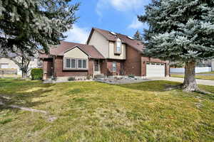 View of front of property with brick siding, concrete driveway, and a shingled roof