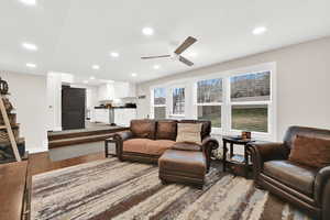 Living area with dark wood-style floors, ceiling fan, and recessed lighting