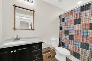 Full bath featuring vanity and shower / bath combo with shower curtain
