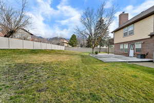 Fenced backyard featuring a patio
