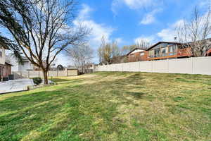 Fenced backyard featuring a residential view