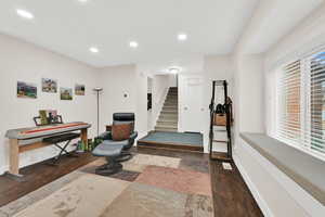 Exercise area featuring dark wood finished floors and recessed lighting