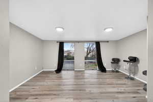Workout room with light wood-style floors