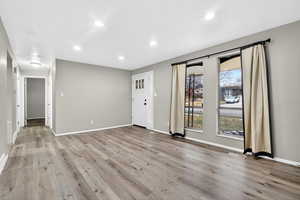 Foyer entrance with recessed lighting and light wood finished floors
