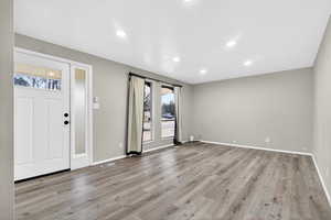 Entryway featuring light wood-style flooring and recessed lighting