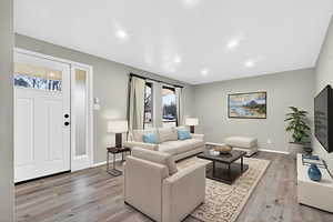 Living area featuring light wood-type flooring and recessed lighting