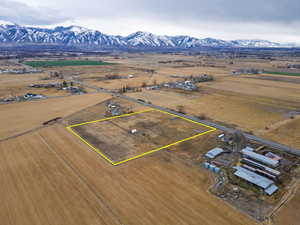 Aerial view of sparsely populated area with property boundaries highlighted and mountains