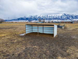 View of pole building with a mountain view and a rural view