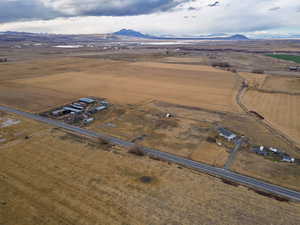 Aerial view of property's location with rural landscape and a mountainous background