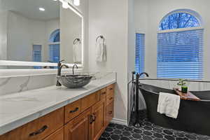 Full bath with vanity and a freestanding tub
