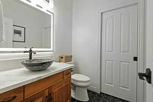 Bathroom featuring vanity and toilet