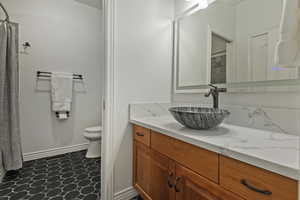 Full bathroom with vanity and curtained shower