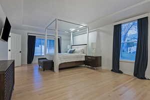 Bedroom with light wood-style flooring and baseboards