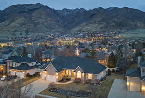 View of front facade with concrete driveway, a garage, and a mountain view