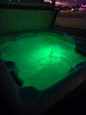 Exterior view of a swimming pool and a fenced backyard