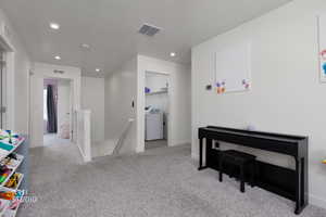 Rec room with light carpet, washer / clothes dryer, recessed lighting, and a textured ceiling
