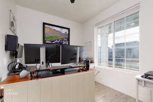 Office with light wood-style flooring and baseboards