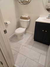 Bathroom with vanity and light marble finish floors