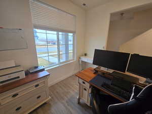Home office featuring baseboards and light wood finished floors