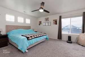 Carpeted bedroom with baseboards and ceiling fan
