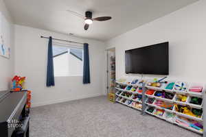 Playroom featuring ceiling fan and carpet flooring