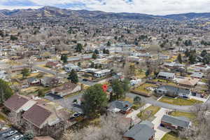 Aerial overview of property's location with mountains and nearby suburban area