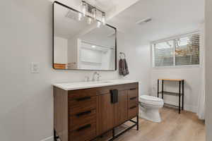 Bathroom featuring vanity and light wood-style floors