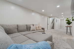 Living room with recessed lighting and light carpet