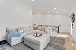 Living room featuring wood finished floors and recessed lighting