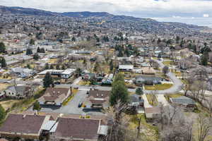 Aerial view of property's location featuring a mountain backdrop and nearby suburban area