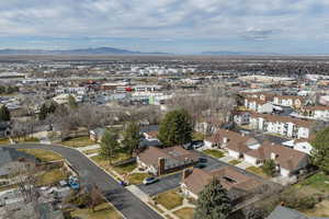 Aerial view of property's location featuring mountains and nearby suburban area