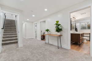 Hall featuring recessed lighting and light colored carpet