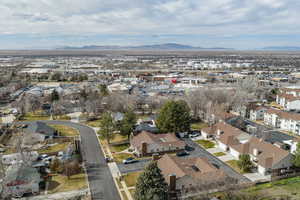 Aerial view of property's location with a mountainous background and nearby suburban area
