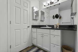 Bathroom with vanity and dark wood-type flooring