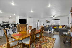 Dining space with wood-type flooring, ceiling fan, and a textured ceiling