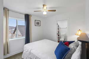 Bedroom featuring carpet flooring, ceiling fan, and ensuite bathroom