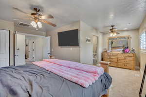 Bedroom featuring a ceiling fan and light colored carpet