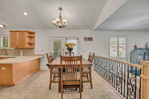 Dining area with suspended lighting and light tile patterned flooring