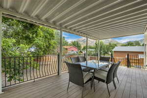 Deck featuring outdoor dining space and a mountain view